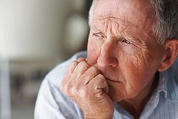 Elderly man lost in thought