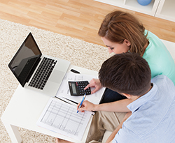 Young couple calculating budget